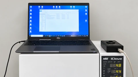 Autoclave with a laptop and measurement device on top.