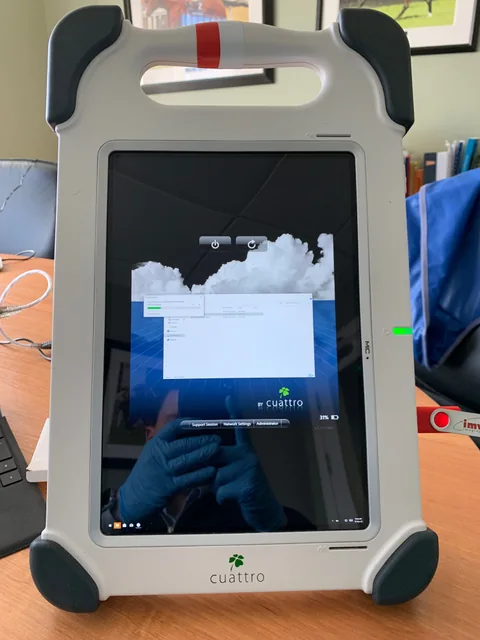 Portable digital radiography workstation with a touchscreen and carrying handle.